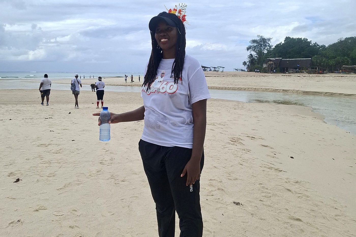 A walker standing at Kongo Beach after completing the journey