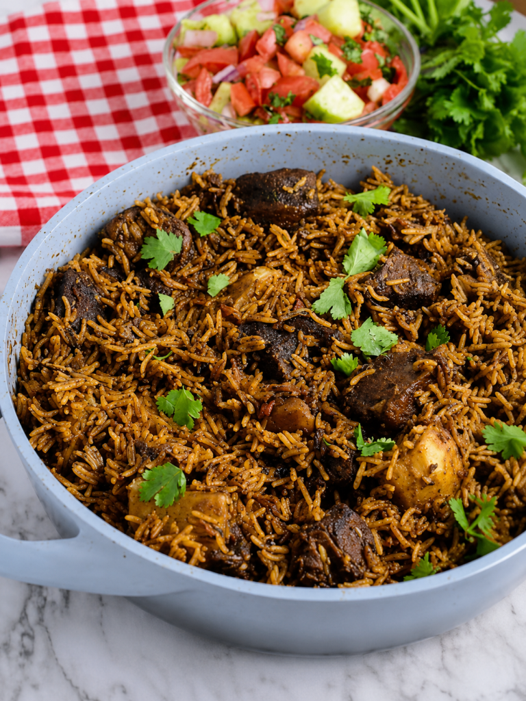 Pot of coastal pilau served with kachumbari.
